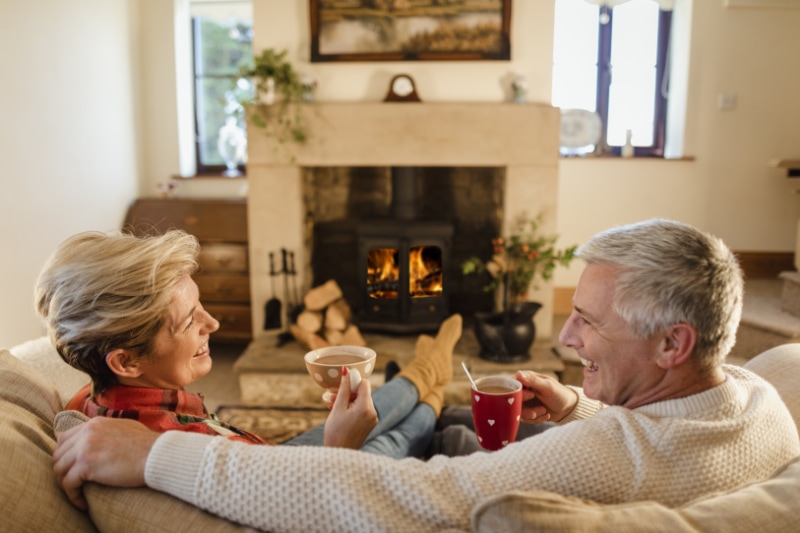 Established couple enjoying the warmth of their home after getting their HVAC system serviced in extreme cold temps. A Taylor Gas Heating Air blog image.